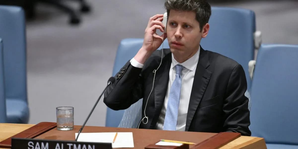 OpenAI CEO Sam Altman sitting at a table while appearing before the UN Security Council and holding an earphone to one ear.